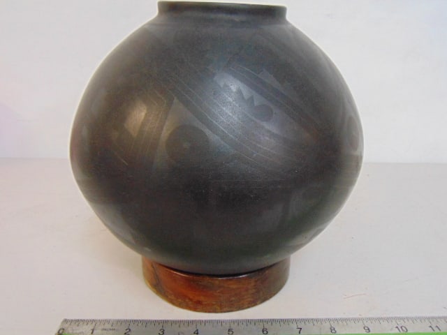 Mexican pot by Virgil Ortiz, in black with black designs, on wood base, signed, 9" in diameter. (1 of 5)