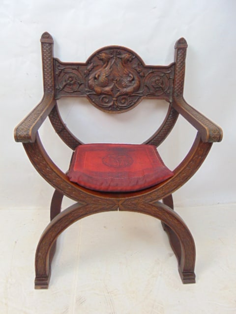 Savonarola chair with carved winged dragons in back support, carved scales on arms, chair is 25": Savonarola chair with carved winged dragons in back support, carved scales on arms, chair is 25" wide, 19" deep, height is 37.5", joints are loose.