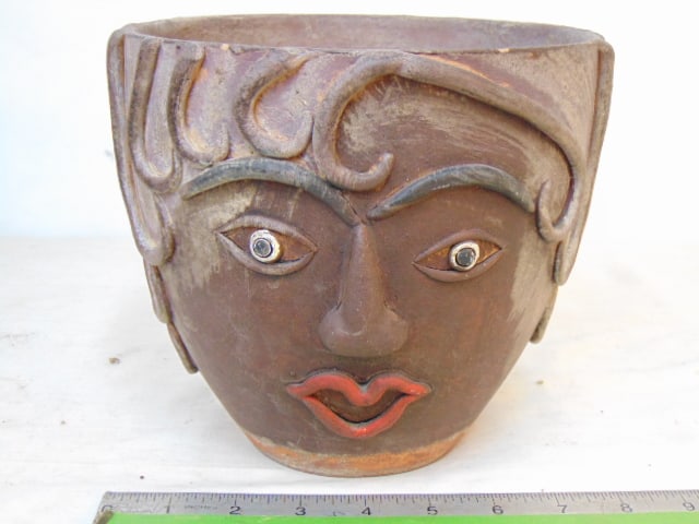 Face planter, in Picasso style, terra cotta planter with applied facial decoration, hair, red lips,: Face planter, in Picasso style, terra cotta planter with applied facial decoration, hair, red lips, has small chip on rim, height is 7", diameter is 8"