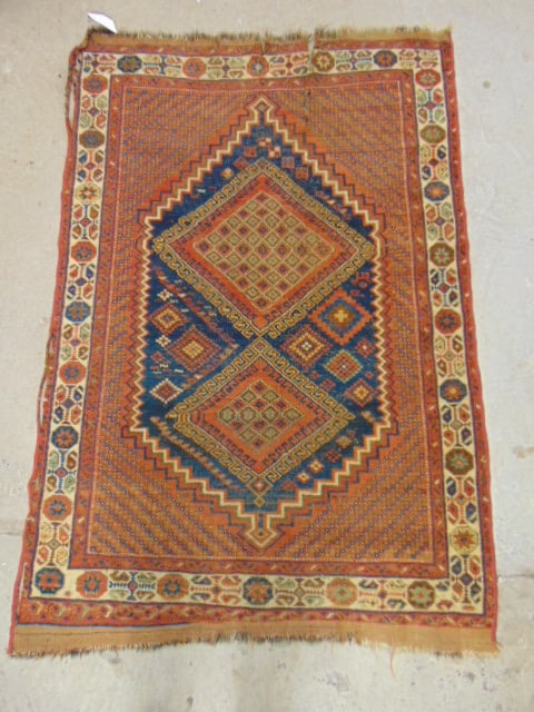 Persian carpet, red with blue center diamond, rug is 67" by 46", several tears (1 of 6)