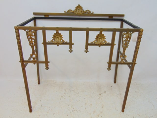 Brass console table, no top, decorative front, legs have been extended with wood plugs, top is 37.5": Brass console table, no top, decorative front, legs have been extended with wood plugs, top is 37.5" by 19.5", height (with wood plugs) is 38"