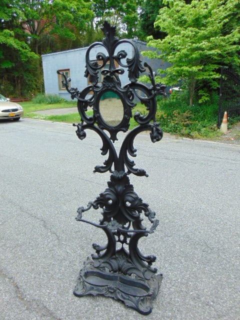 Cast iron hall tree with umbrella pan, 4 hooks & small mirror, height is 76", in black paint, (1 of 9)