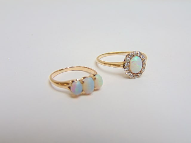 Jewelry. (2) Opal rings. 14kt oval opal surrounded by 14 small diamonds, size 6 1/2, 1.80 grams. & (1 of 6)