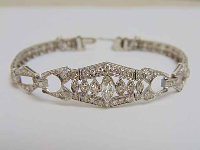 Jewelry. Platinum Diamond Art Deco bracelet w/ central marquise diamond, approx 3mmx7mm flanked by (1 of 10)