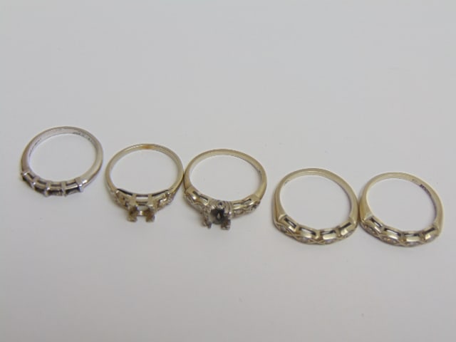 Collection of Gold rings to include two 14kt white gold bands with diamond chips both size 6 1/2, (1 of 3)