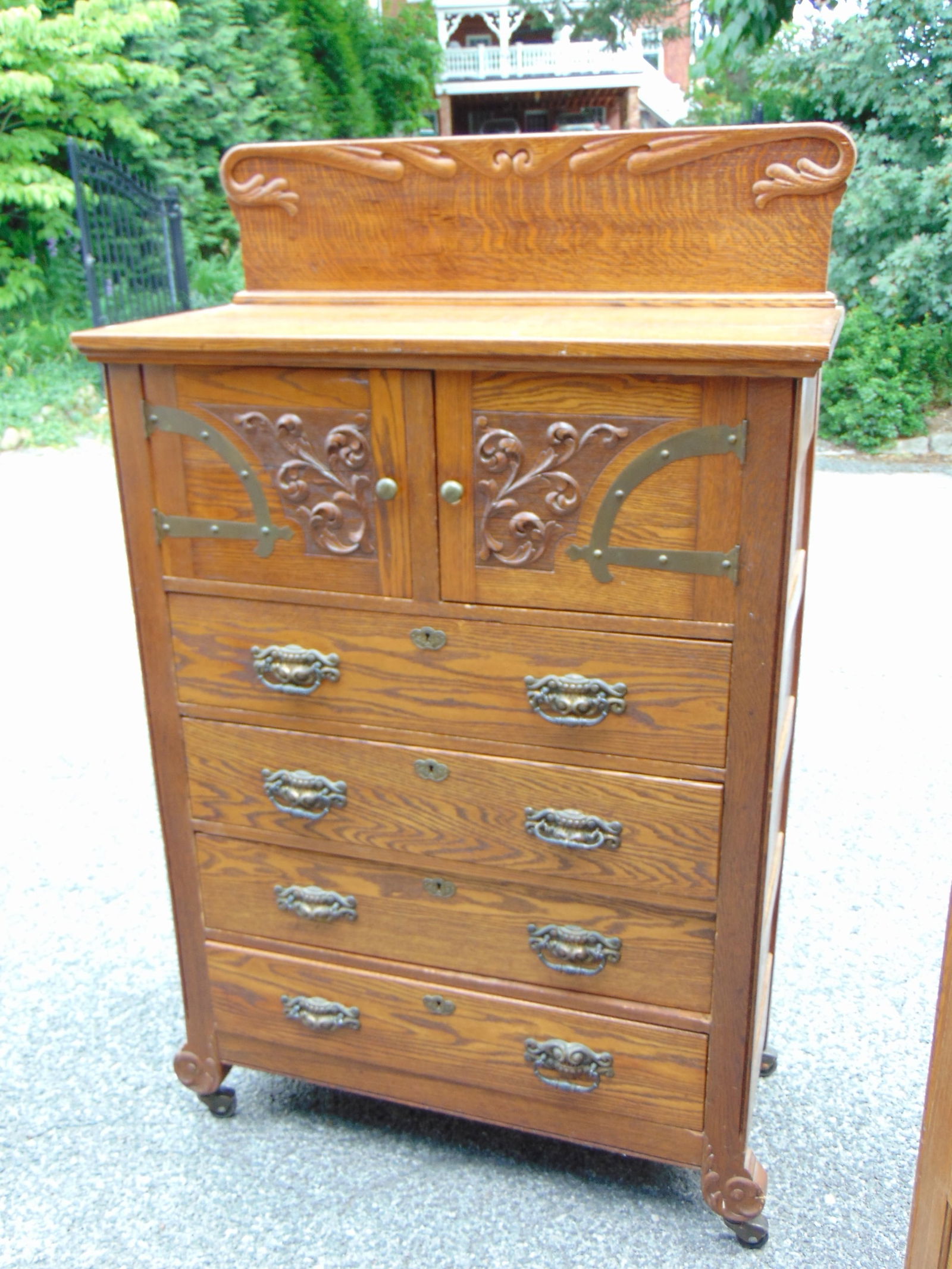 Oak bonnet chest with 2 doors over 4 drawers, brass hardware, cxarved detail, chest as 39.25" by 18. (1 of 5)