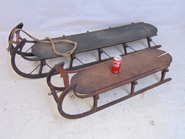 2 vintage sleds, curved fronts, one sled is 55", other is 39", larger sled in dark green paint with (1 of 7)