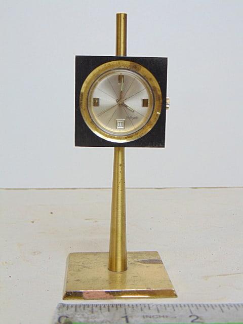 Lafayette desk watch, paperweight, on brass base, steel case, height is 4.75", does not run: Lafayette desk watch, paperweight, on brass base, steel case, height is 4.75", does not run