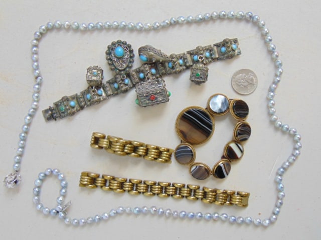 Jewelry. 800 charm bracelet with charms; tiger eye bracelet; 2 brass bracelets; & "pearl" necklace (1 of 7)