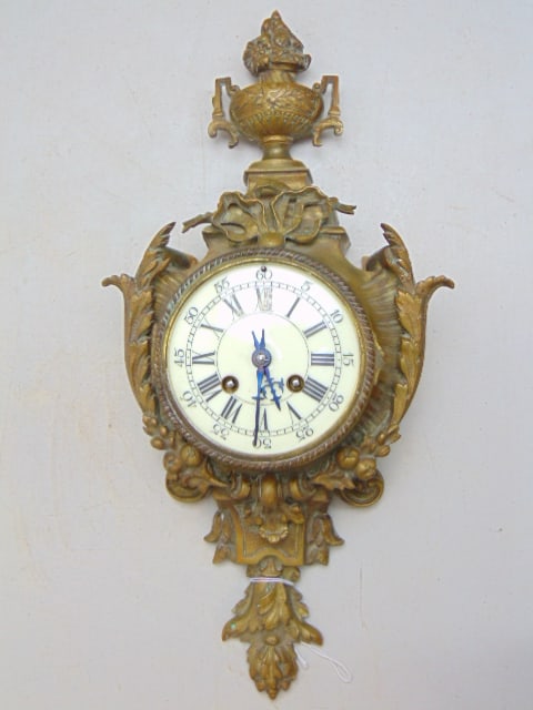 French bronze cartel clock, glass bezel missing, ornately decorated with urn, wreath, height is: French bronze cartel clock, glass bezel missing, ornately decorated with urn, wreath, height is 18.25"