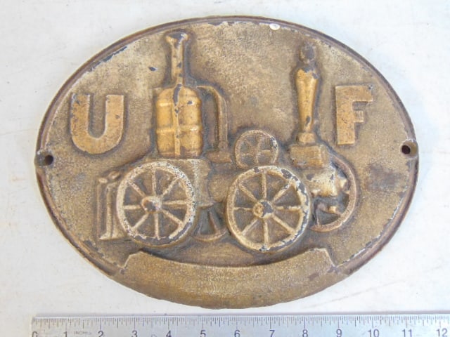 Cast iron firemarker, "U.F." & fire fighting apparatus, oval, 11.5" by 9" (1 of 4)