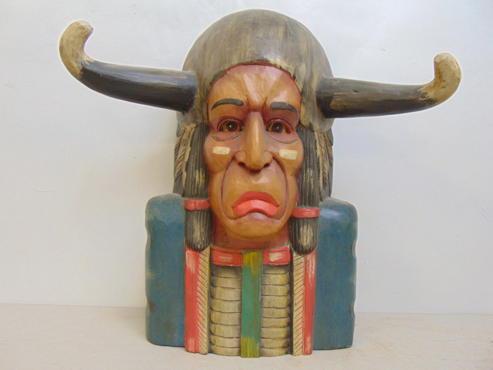 Carved wood polychrome carved Native American with horns, 1930's: Carved wood polychrome carved Native American with horns, circa 1930's, 18.5" tall, width at horns is 18.25"