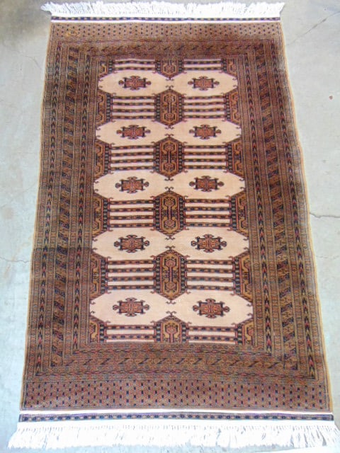 Bokhara style carpet, beige brown colors, moderate wear, rug is 75" by 48", signed (1 of 5)