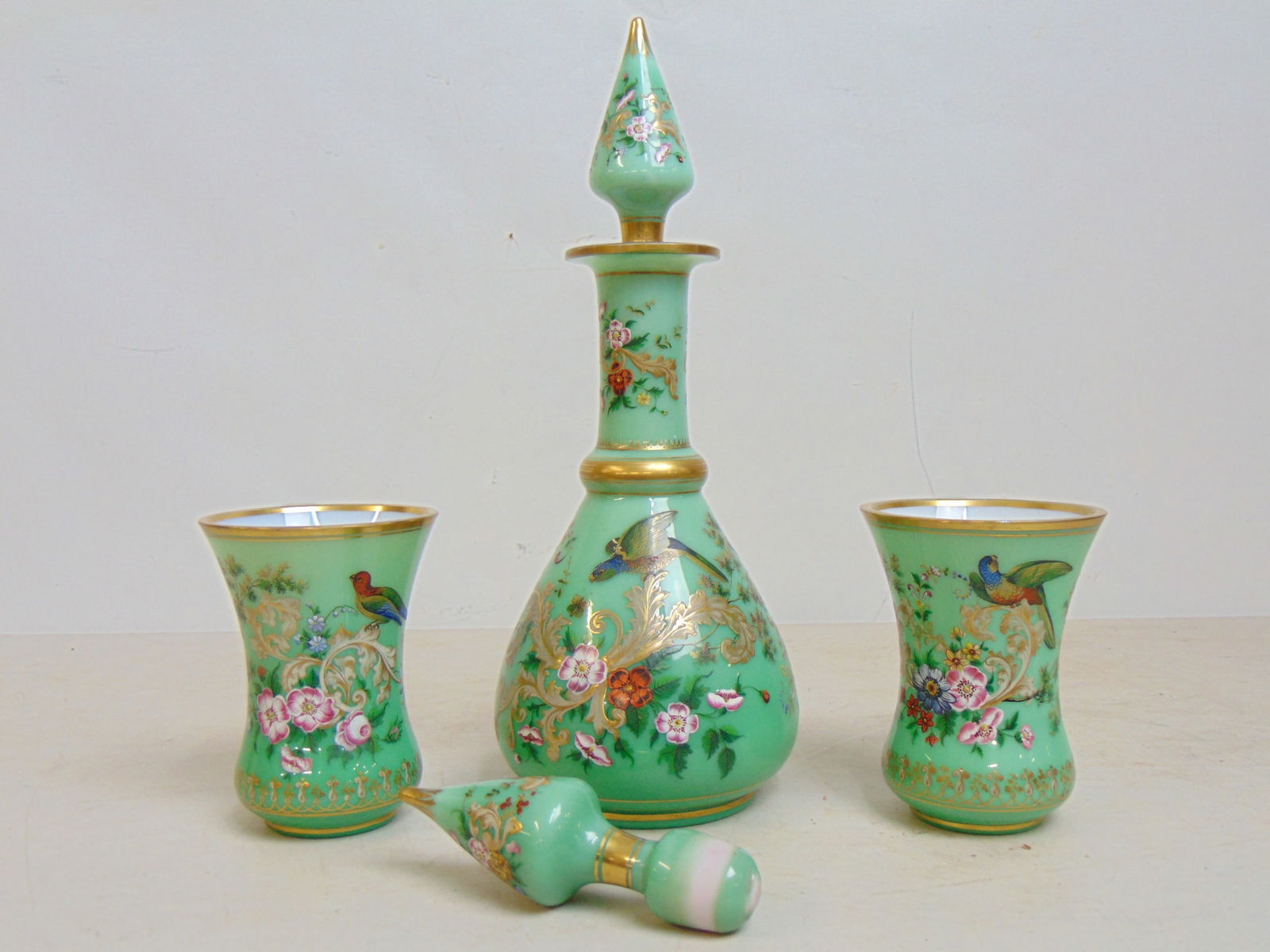 Green enameled decanter & 2 cups with gilt accents, exotic birds & flowers, 19th Century, comes with (1 of 8)