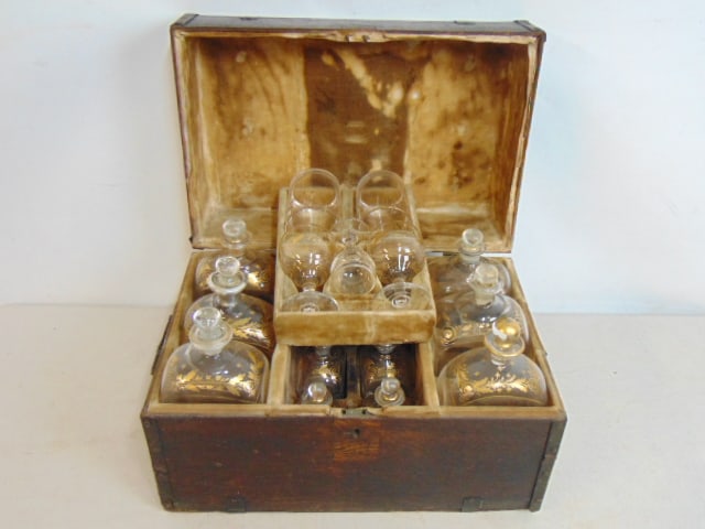 Campaign bar with gilt decorated decanters & glasses, in original bood, velvet lined box, contains 6: Campaign bar with gilt decorated decanters & glasses, in original bood, velvet lined box, contains 6 large decanters, 6 small decanters, 2 wine, 2 whiskey & one small cordial, box is 16.25" by 10.75",