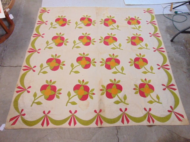 Quilt with fruit on branches, ribbon edge, green, red & yellow on ivory field, has stains, quilt is: Quilt with fruit on branches, ribbon edge, green, red & yellow on ivory field, has stains, quilt is 81" by 80"