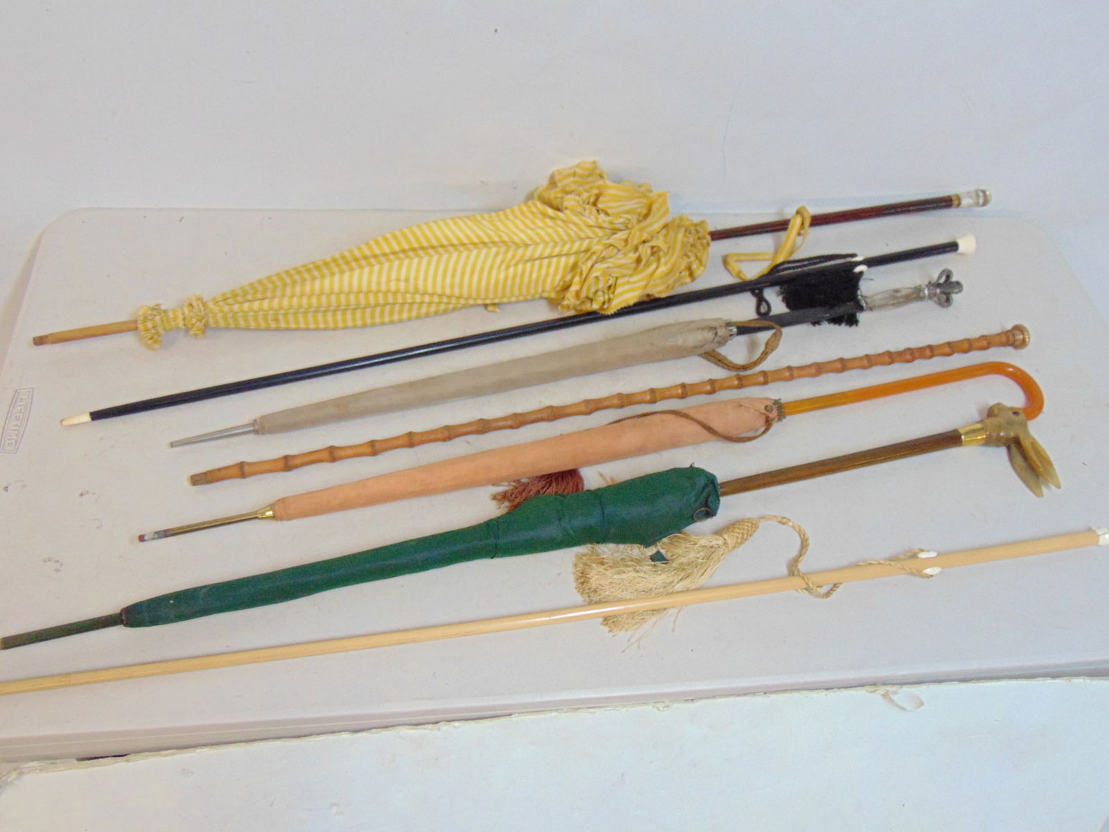 7 canes & umbrellas or parasols, various design, wood, bone, ebony & ivory, bamboo, silver (plate ?): 7 canes & umbrellas or parasols, various design, wood, bone, ebony & ivory, bamboo, silver (plate ?) one has carved rabbit handle