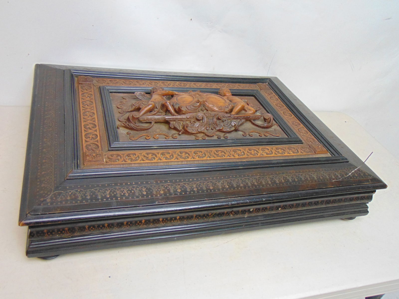 19th Century flat box with carved wood lid, ebonized case with inlaid decoration, lid has armorial (1 of 13)