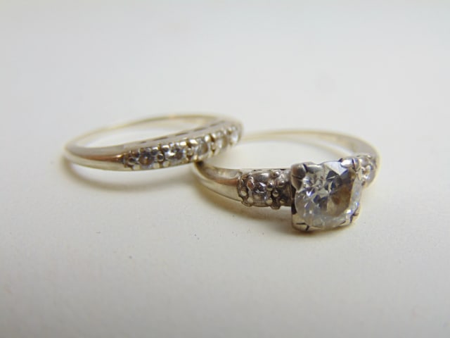 JEWELRY. 14kt white gold Engagement set, total weight 4.05 grams, both size 5 1/2, band has 5 small: JEWELRY. 14kt white gold Engagement set, total weight 4.05 grams, both size 5 1/2, band has 5 small diamonds, central diamond approx 5mm with one small diamond on each side.