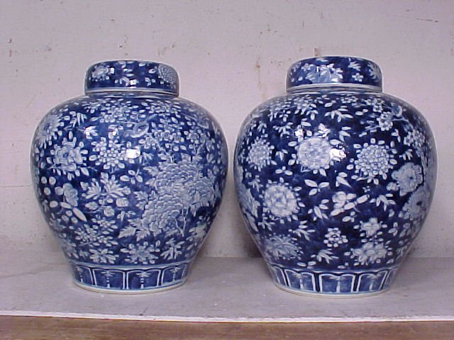 Pair blue & white porcelain ginger jars: Pair blue & white porcelain ginger jars with lids, extensively decorated with birds, trees, flowers & leaves, in good condition with minor glaze chips on rim, total height is 9.75"
