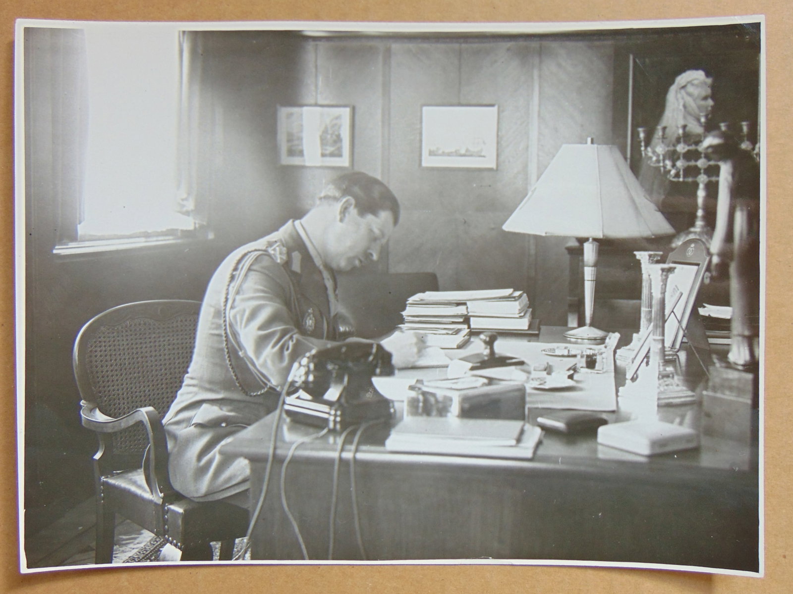 Iosif Berman photograph, King Carol II king of Romania seated behind his desk, a picture of the late: Iosif Berman photograph, King Carol II king of Romania seated behind his desk, a picture of the late Queen Elizabeth, wife of late king Carol I visible on the wall 6.75" by 9.25"