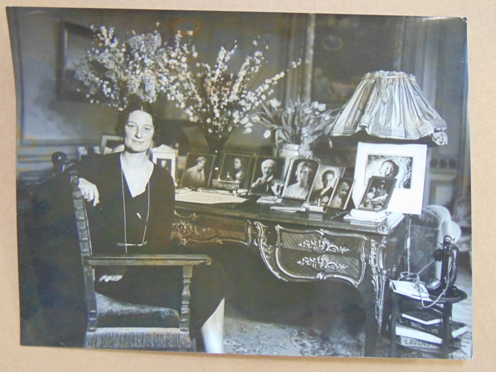 Photograph, attributed to Alfred Eisenstaedt, Princess Astrid of Sweden seated besides her desk, (1 of 3)