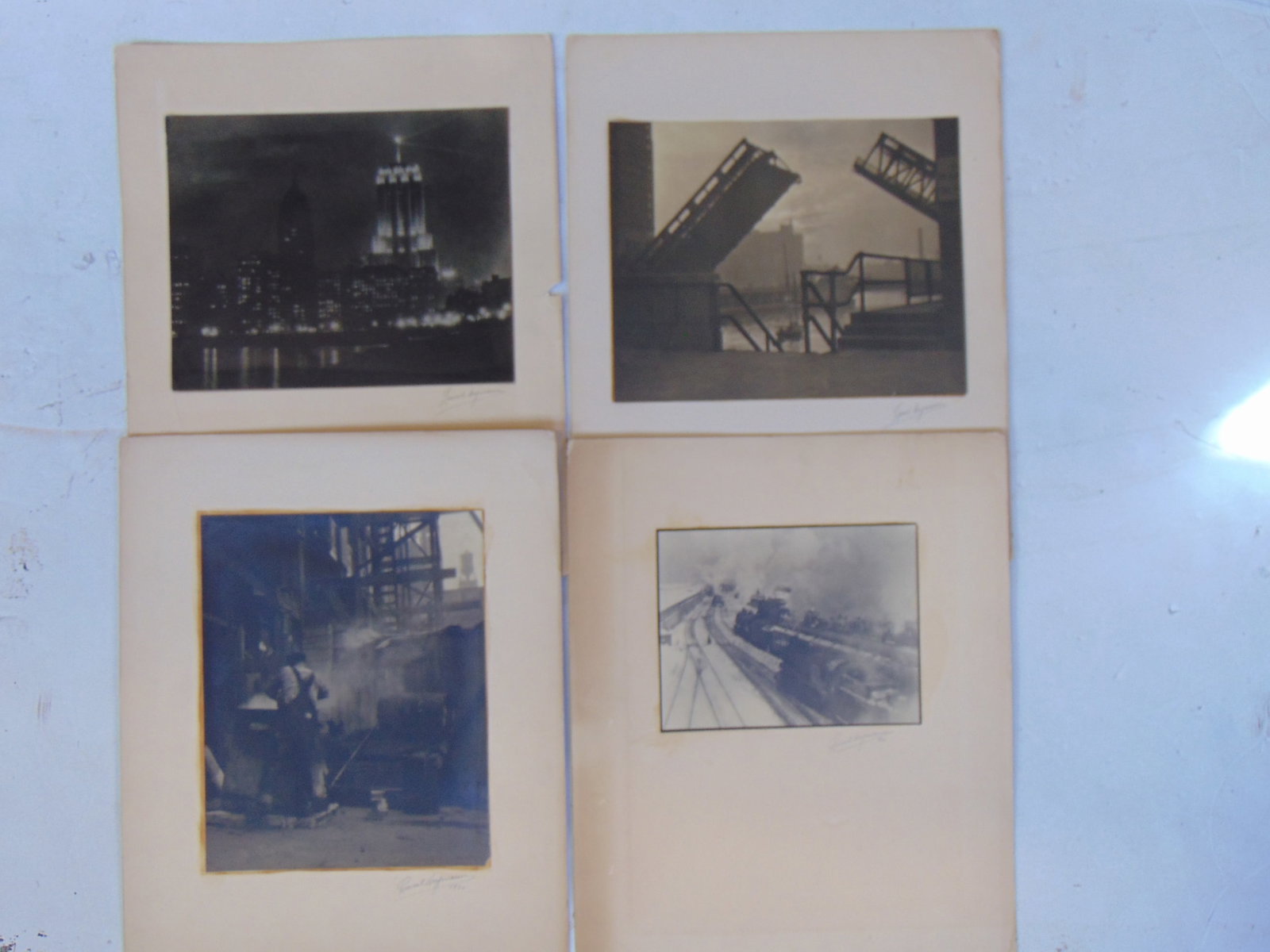 4 photographs by Lionel Heymann, for the Fort Dearborn Camera Club, Chicago, 1930's, includes: 4 photographs by Lionel Heymann, for the Fort Dearborn Camera Club, Chicago, 1930's, includes "Polmolive Building"; Open Bridge"; "The Toiler"; "Journey's End", various sizes, signed with labels (some