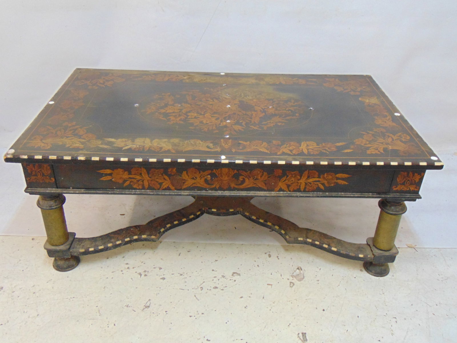 Italian inlaid table, cut down to coffee table, floral inlay in exotic woods & bone, on column legs,: Italian inlaid table, cut down to coffee table, floral inlay in exotic woods & bone, on column legs, top distressed, needs restoration, table is 50.5" by 29.25", height is 19.75"