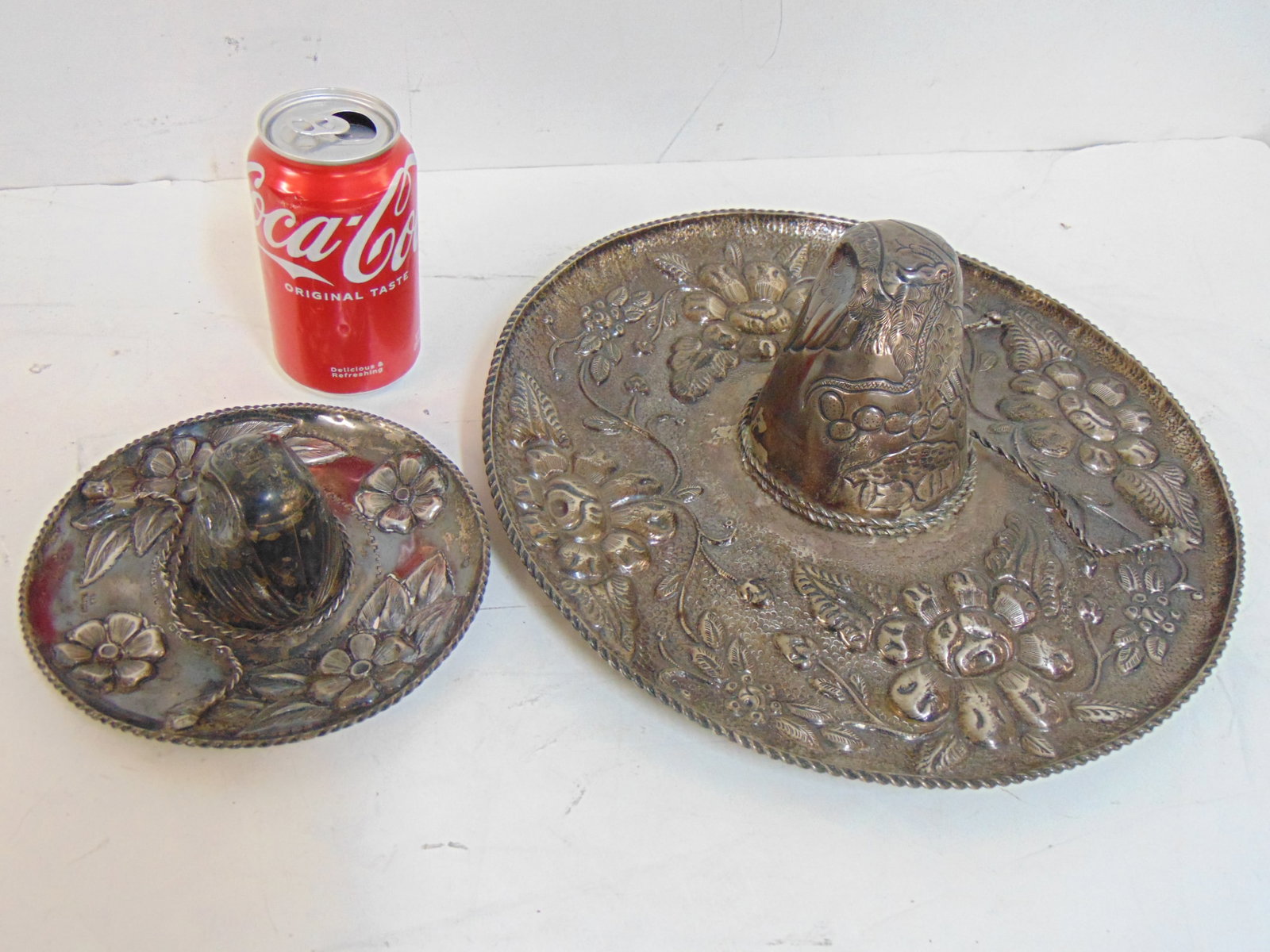 2 silver sombreros, floral decorated, large sombrero is 13.5" in diameter, small sombrero is 6.5",: 2 silver sombreros, floral decorated, large sombrero is 13.5" in diameter, small sombrero is 6.5", 28.5 troy, marked 925.