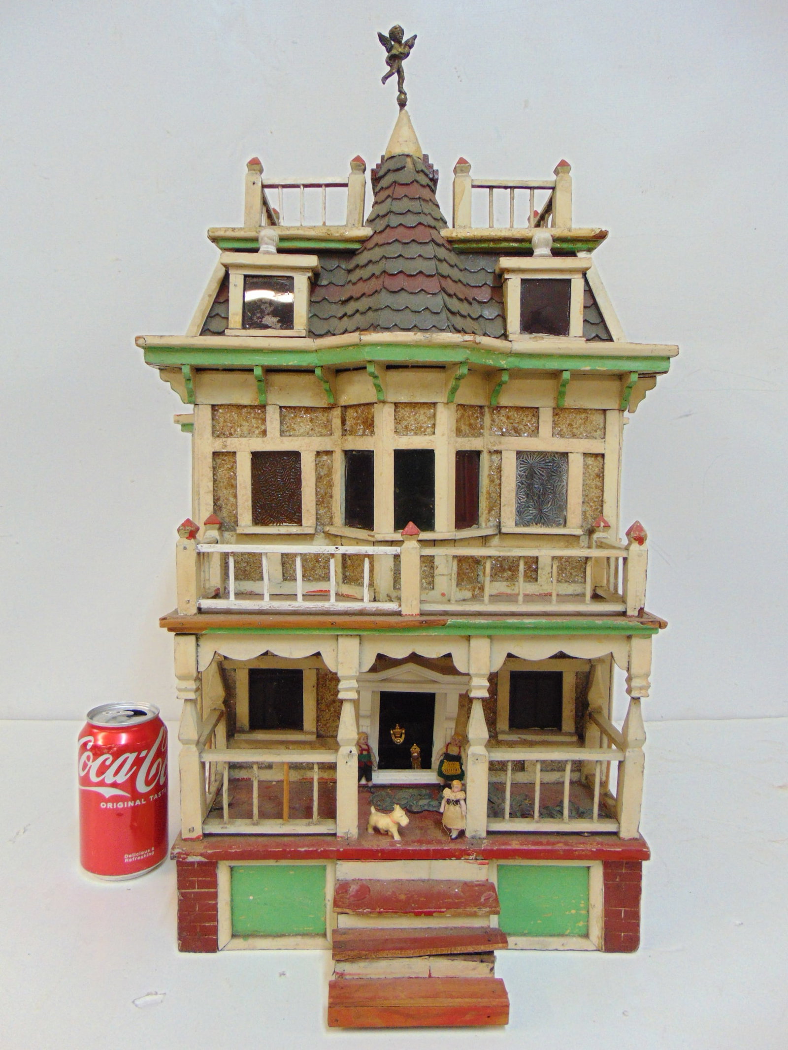 Miniature Victorian dollhouse with detailed windows, double porch, figures, back hinges open, base: Miniature Victorian dollhouse with detailed windows, double porch, figures, back hinges open, base is 19.25" deep, 16" wide, height is 25.5"