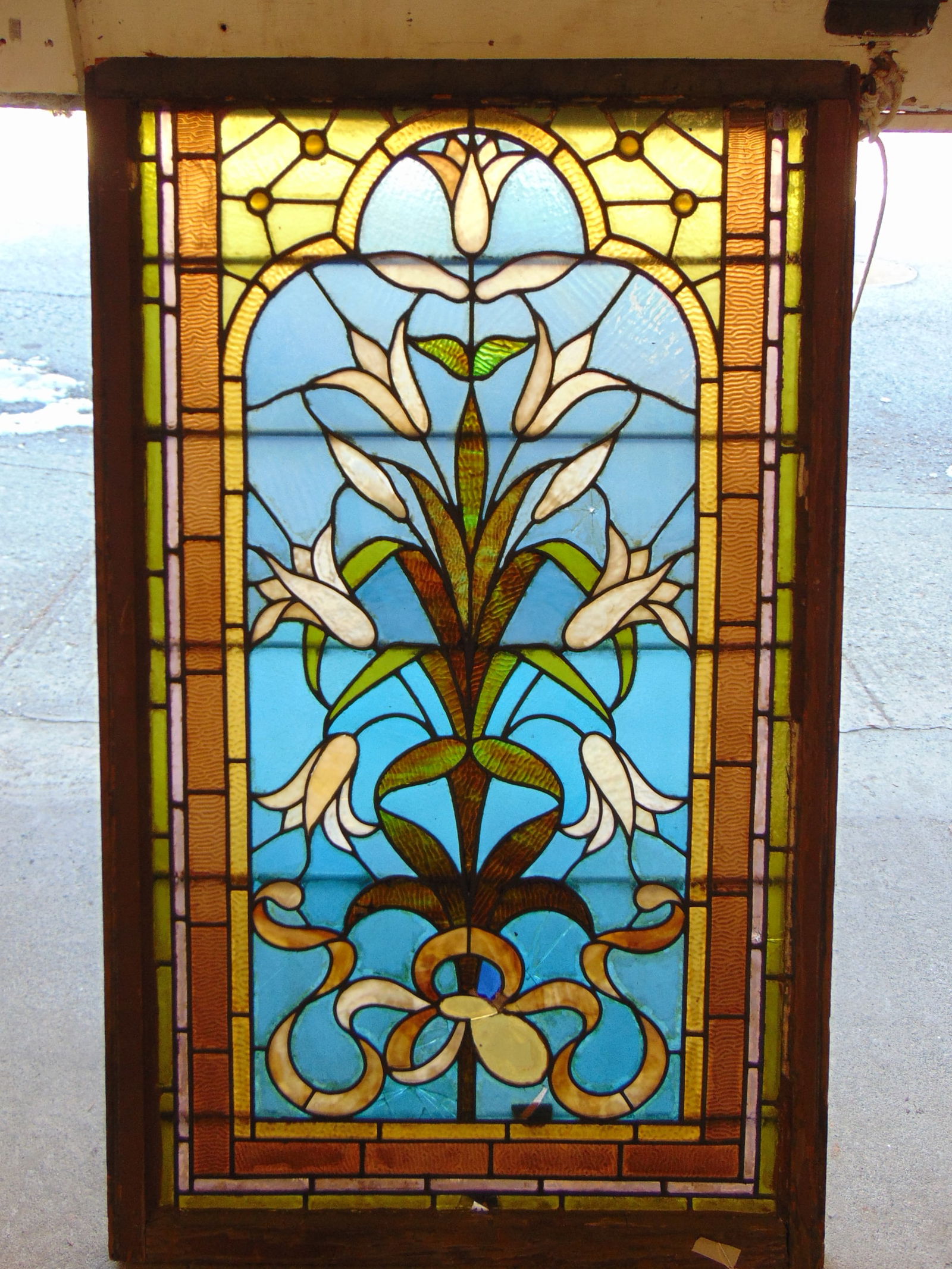 Leaded glass window, floral & ribbon decorated, window is 54.5" by 34", has several cracked panels, (1 of 8)