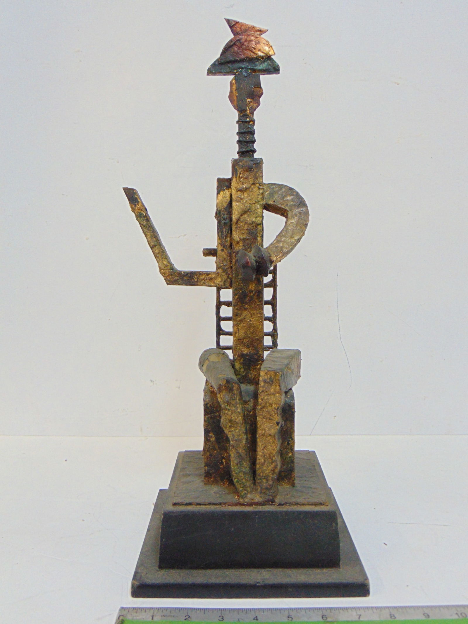 Brutalist style sculpture of a figure in a chair. unsigned, (1 of 5)