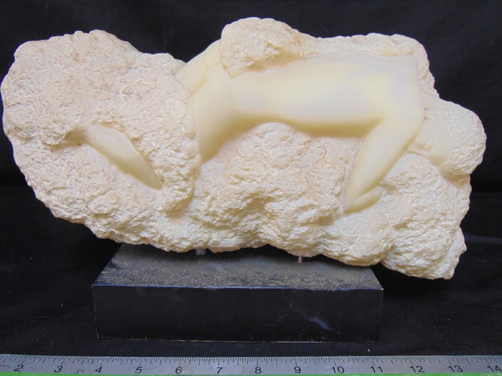 Resin sculpture of a nude figure in rock, by Peggy Mach, 14.5" long, height as shown is 9": Resin sculpture of a nude figure in rock, by Peggy Mach, 14.5" long, height as shown is 9"