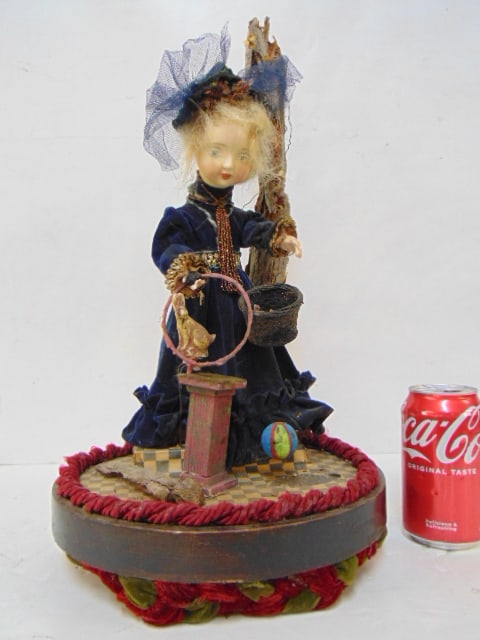 Automaton with music box, girl in velvet dress with rabbit, figure bows when wound, height is 19",: Automaton with music box, girl in velvet dress with rabbit, figure bows when wound, height is 19", not old.