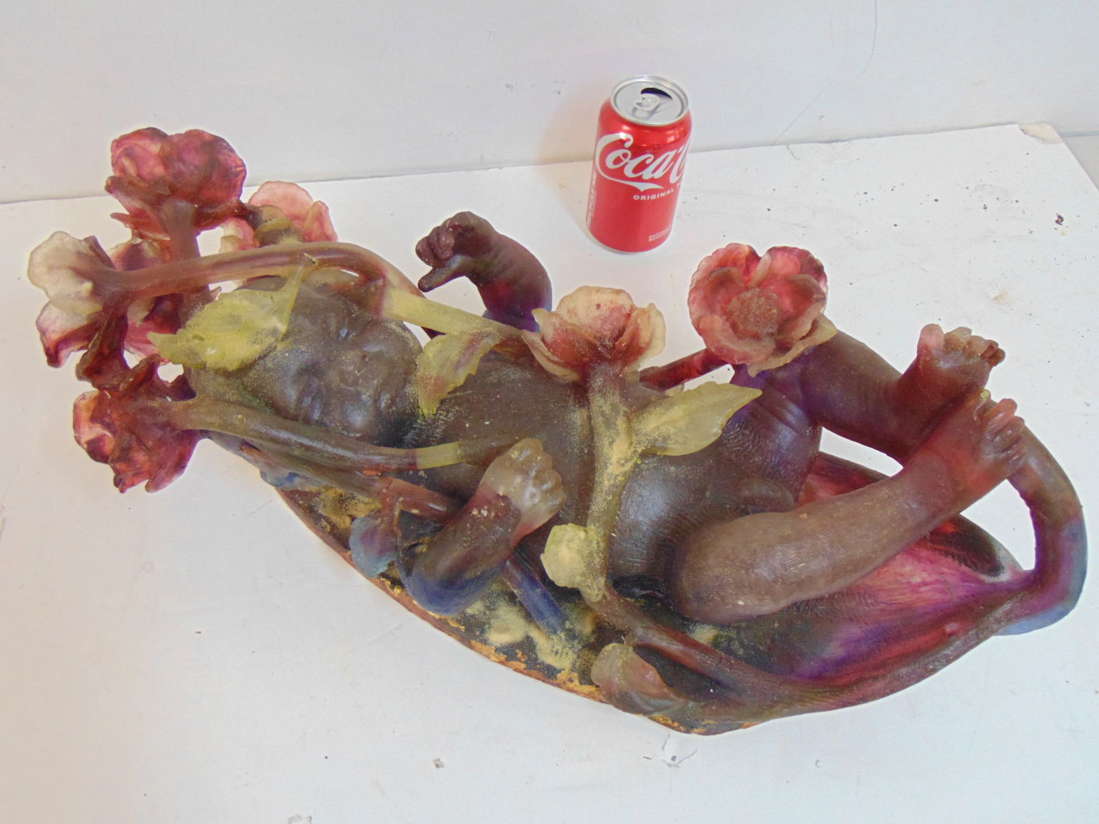 MCM or possibly later glass sculpture, baby sleeping in flowers, in red, green, sculpture is: MCM or possibly later glass sculpture, baby sleeping in flowers, in red, green, sculpture is unsigned, 22" long, 9" wide