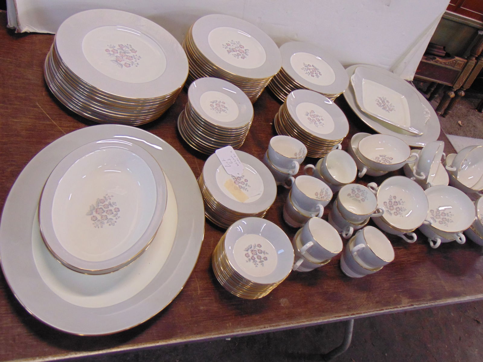 Large set of Wedgwood Bone China, floral pattern with grey border accented with gilt,: Large set of Wedgwood Bone China, floral pattern with grey border accented with gilt, includes 12 dinner plates, 18 lunch plates, 12 bread plates, 12 double handled soup bowls with saucers, 12 cups &