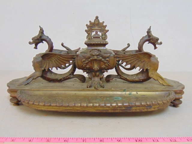 Ornate brass inkwell with winged dragons flanking ink reservoir, with pen tray, inkwell has (1 of 4)