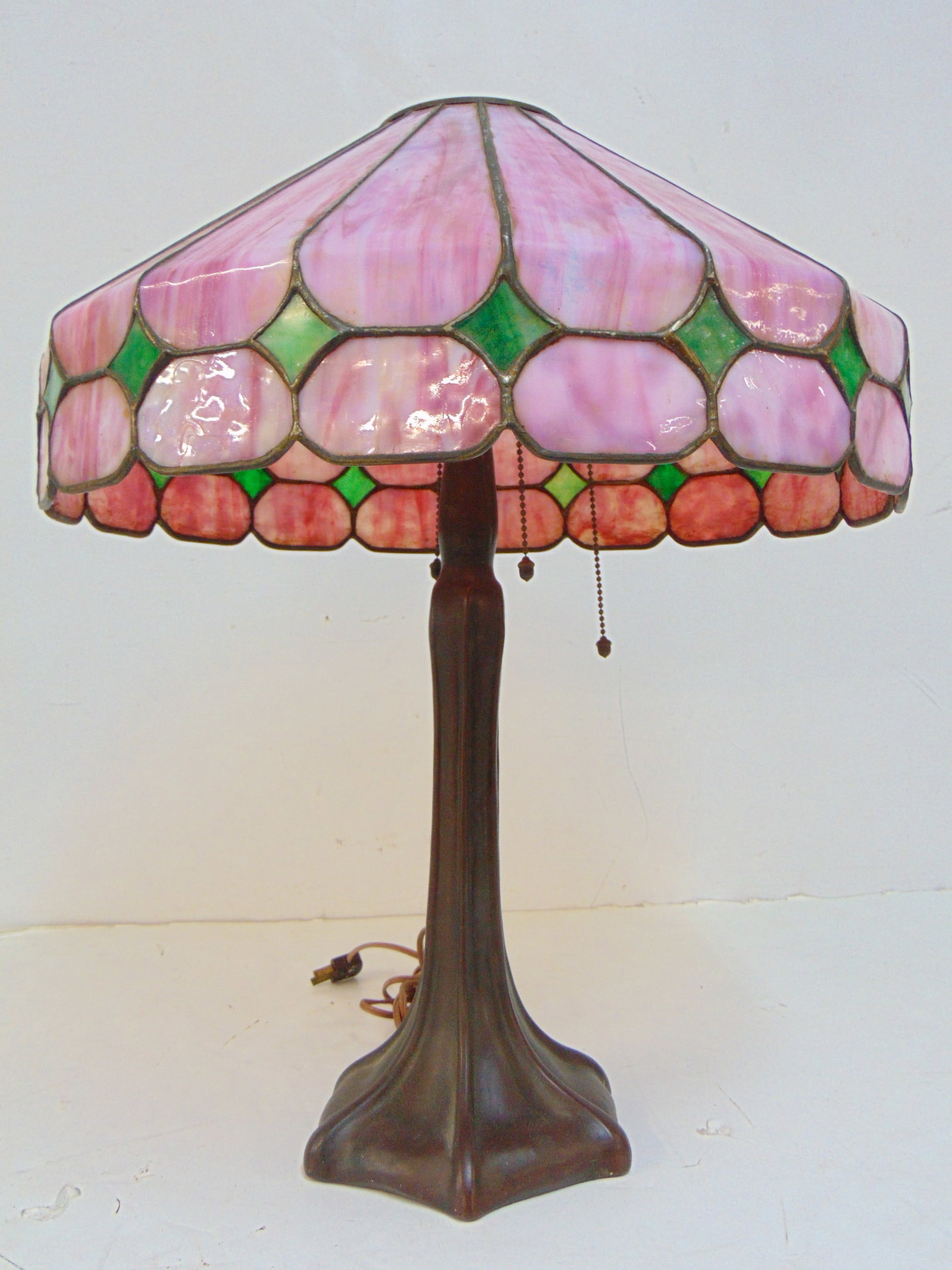 Handel table lamp with pink paneled shade, lamp is 22" tall, diameter shade is 18", glass is in good: Handel table lamp with pink paneled shade, lamp is 22" tall, diameter shade is 18", glass is in good condition. Top fitting not original