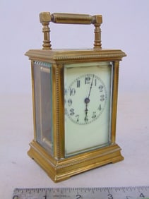 Small carriage clock, brass case with beveled glass, no make, with key, case is 5.25" tall (incl.