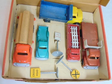 Structo Toys No. 95 Truck set in original box, 5 die cast metal trucks, 3 metal road signs & 3 logs,