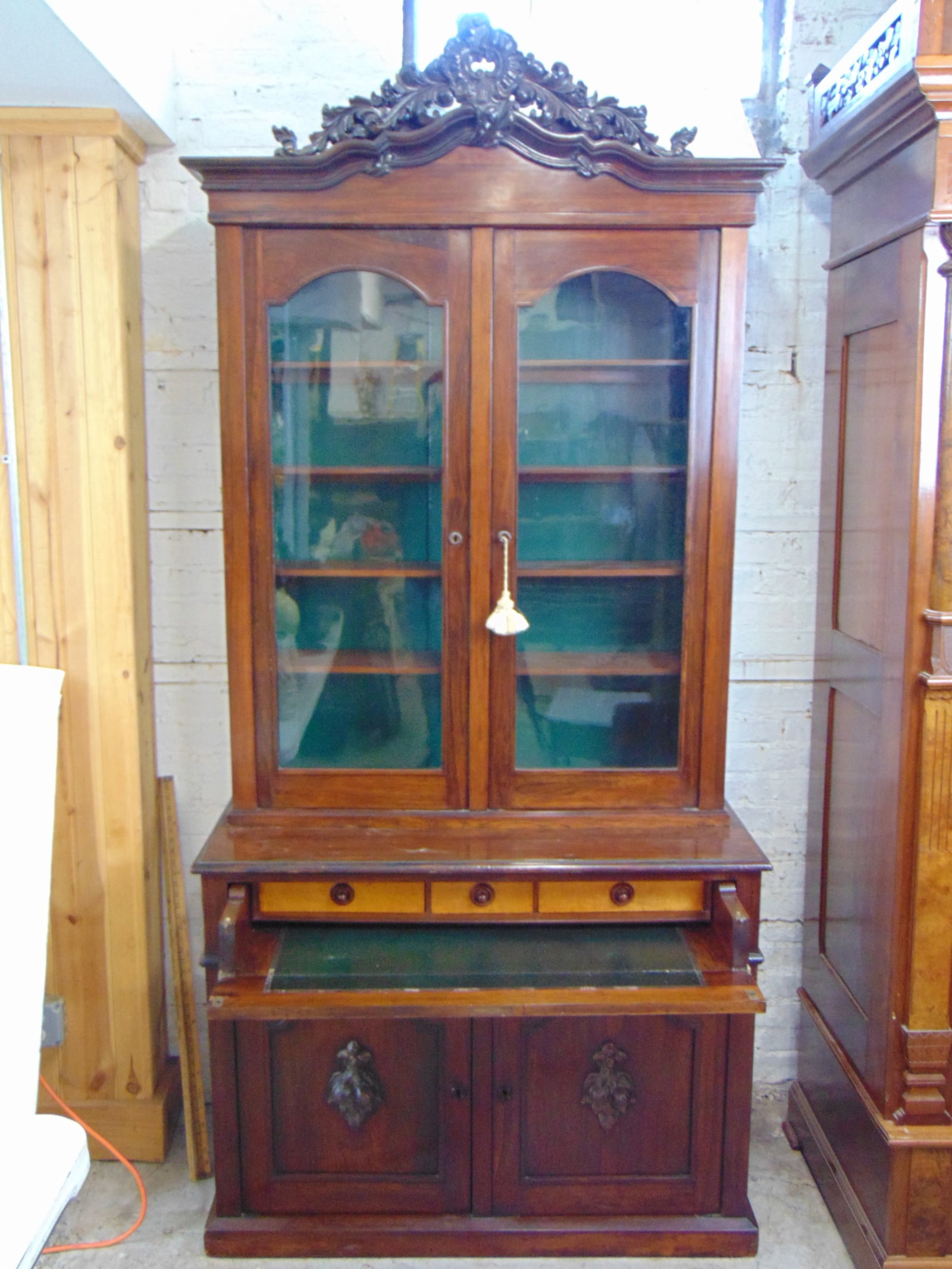 Rosewood secretary with carved crest, butlers desk drawer, cabinet is 44.5" wide, 20" deep, height: Rosewood secretary with carved crest, butlers desk drawer, cabinet is 44.5" wide, 20" deep, height is 95.5"