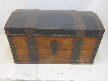 Early German trunk with oak sides, leather covered domed top and decorative metal bands, comes with