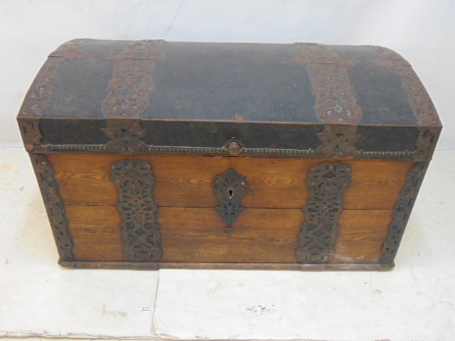 Early German trunk with oak sides, leather covered domed top and decorative metal bands, comes with (1 of 8)