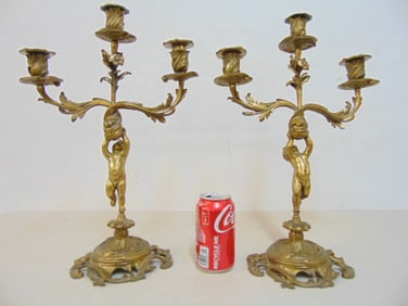 Pair solid brass candelabra with putti bases, 3 arms, height is 17", width is 11.5"
