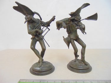 Pair figural Spelter candle holders, jester playing mock instruments, 11 3/8" tall.