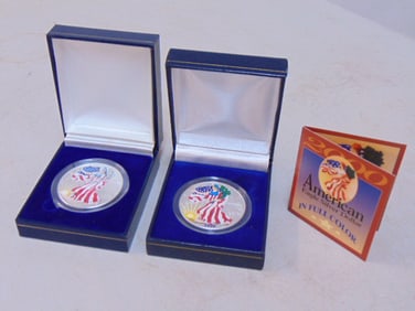 2 American Eagle silver dollars in color, 1999 & 2000, United States Mint, in blue cases.