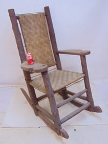 Oversized rustic rocker, Adirondack style, bark frame, woven seat & back, seat is 22" deep, 23.5"