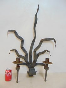 Large iron wall sconce with leaf decoration and two arms, height is 34.5", width is 22.75"