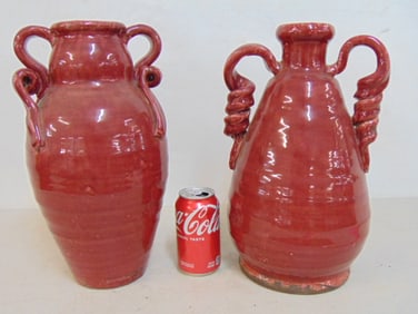 2 large pottery vases in red glaze, both with handles, no make, vases are 14 & 14.5" tall.