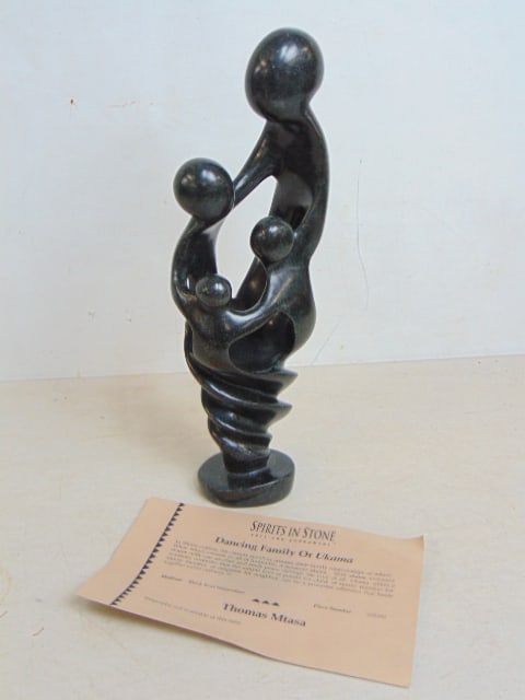 Stone carving, "Dancing Family or Ukama", by Thomas Mtasa, in carved black Iron Serpentine, height: Stone carving, "Dancing Family or Ukama", by Thomas Mtasa, in carved black Iron Serpentine, height is 13 7/8"